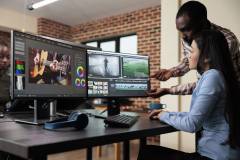 Creative agency video graphic editor expert enhancing footage using visual timeline and advanced software.
